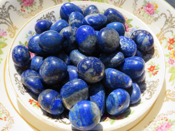 A plate of polished blue lapis lazuli stones.