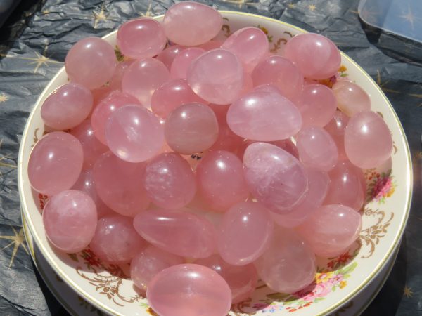 Bowl of pink rose quartz stones.