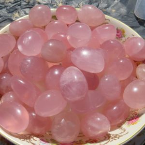 Bowl of pink rose quartz stones.