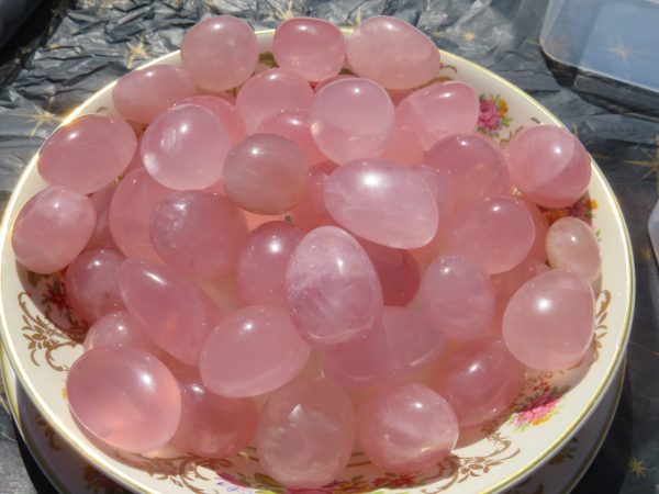 Bowl of pink rose quartz stones.