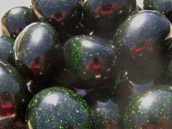 Green glitter balls with reflections.