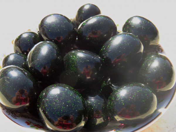 Black and green speckled eggs in a bowl.