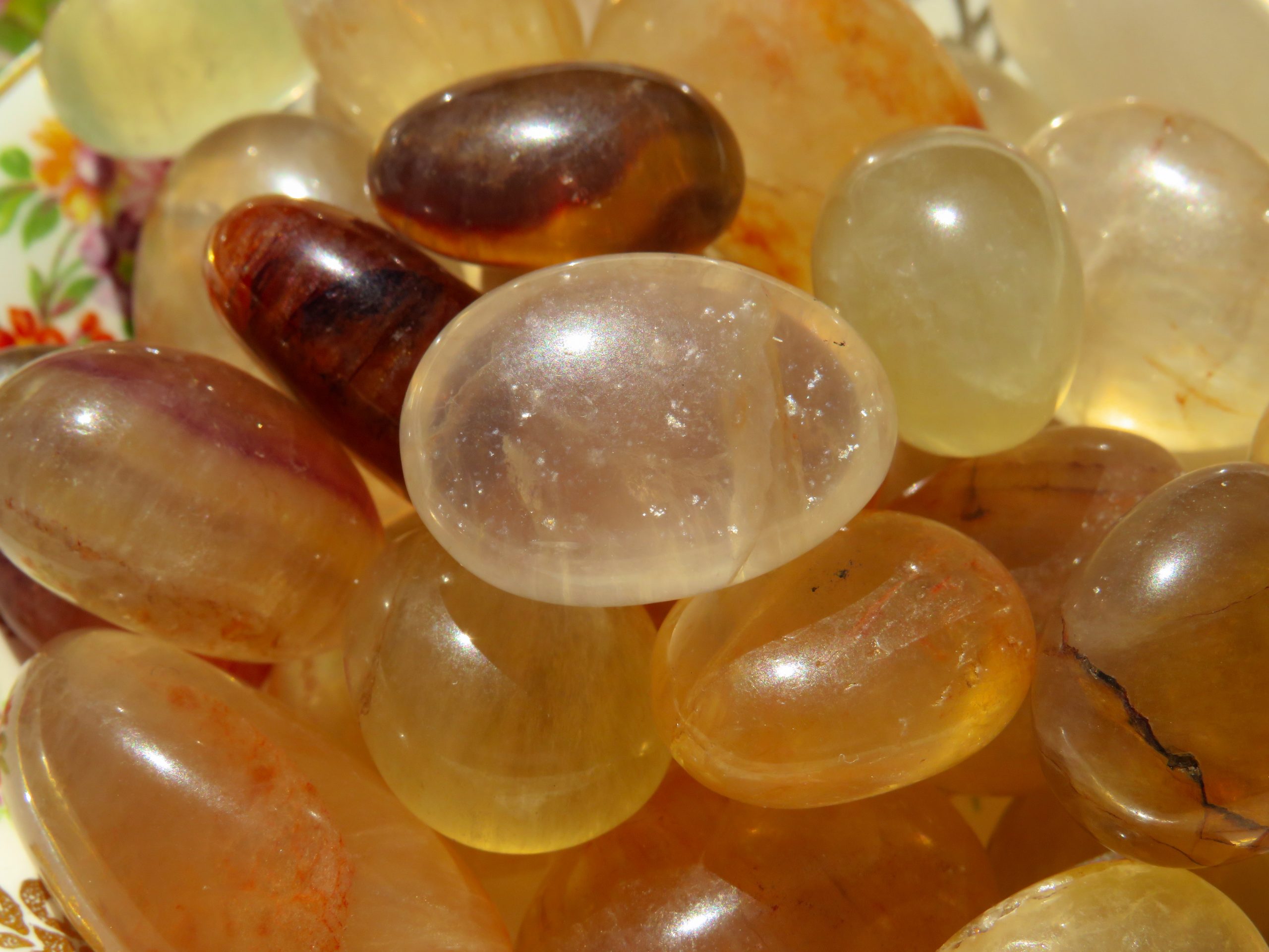 A pile of smooth, yellow gemstones.