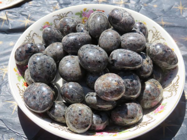 Collection of black and gray tumbled stones.