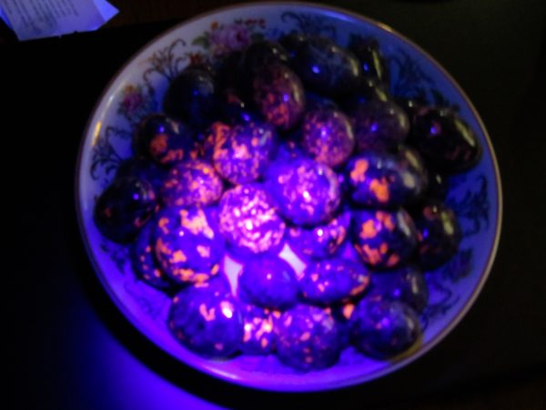 Purple stones in a decorated bowl.