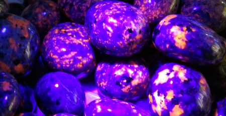 Purple and orange glowing rocks under black light.