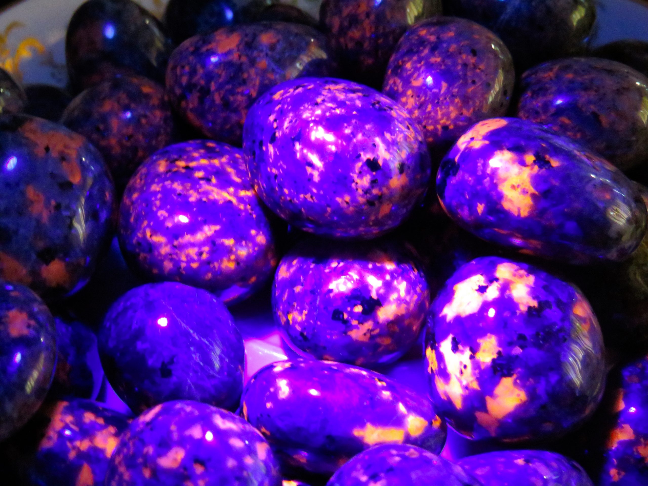 Purple and orange glowing rocks under black light.