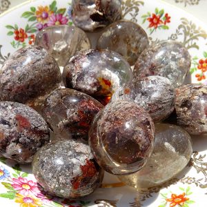 Polished stones with inclusions on a plate.