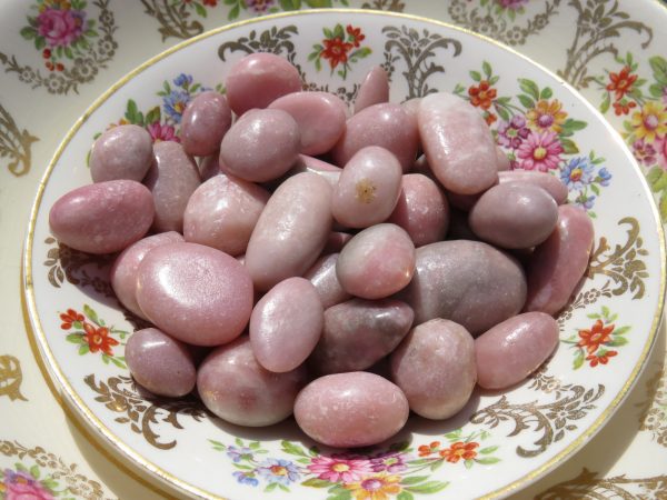 Pink tumbled stones on a plate.