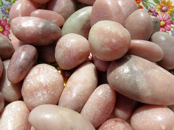 Pink and grey smooth stones in a bowl.
