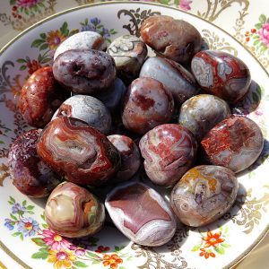 Red and white banded agate stones on a plate.