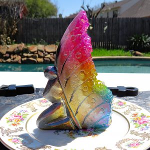 Rainbow crystal butterfly on a plate.