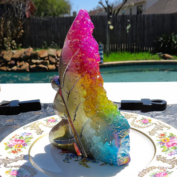 Rainbow crystal butterfly on a plate.