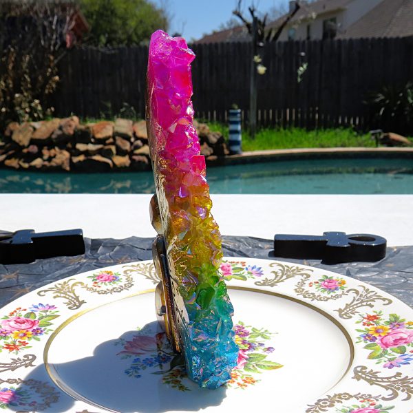 Rainbow crystal on a floral plate.