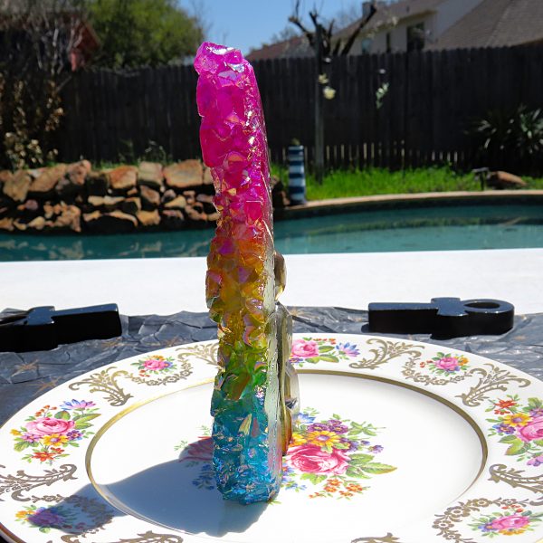 Rainbow crystal on a floral plate.