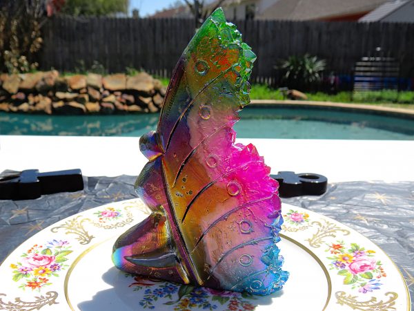 Iridescent glass butterfly on plate