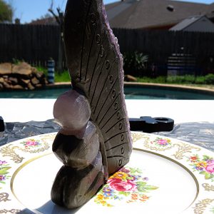 Stone sculpture on a floral plate.