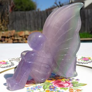 Amethyst fairy figurine on a plate.