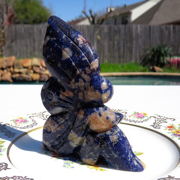 Carved blue stone butterfly figurine.