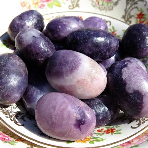 Purple and white stones on a plate.