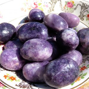 Purple gemstones on a floral plate.