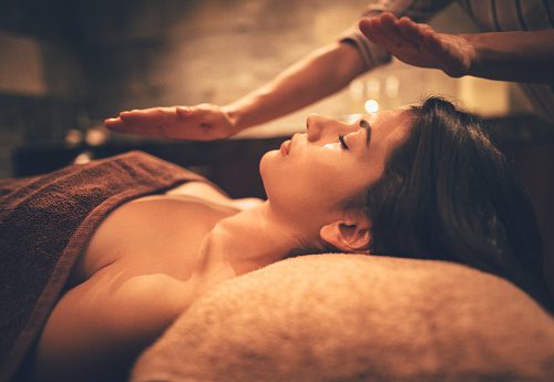 A woman getting a massage at a spa in brown image in color