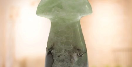 A green jade mushroom sitting on a table in a living room.