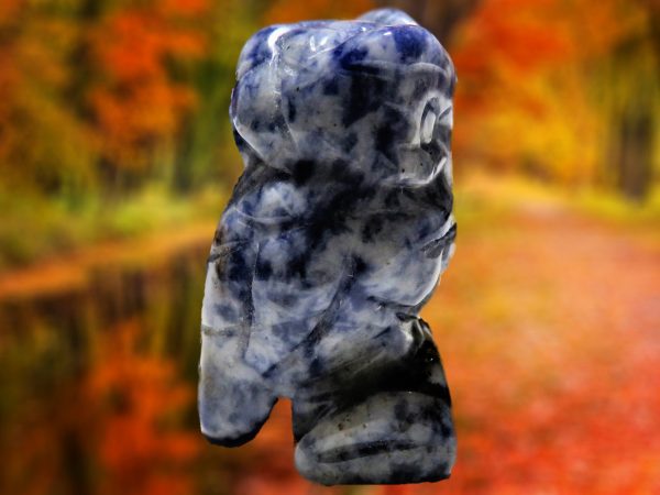 Blue and white stone owl carving.
