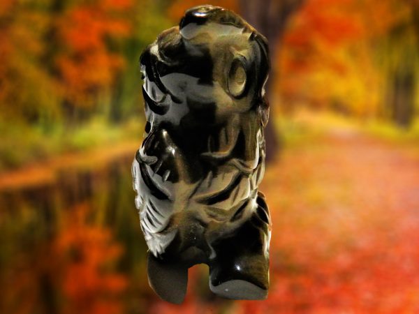 Black obsidian sculpture of a face.