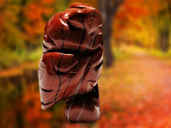 Carved red jasper owl figurine.