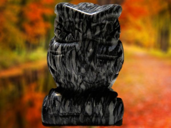 Black and white owl statue carved from stone.