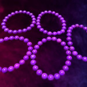 Four purple beaded necklaces on dark background.