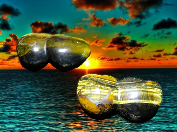 Two tiger's eye stones on the ocean.
