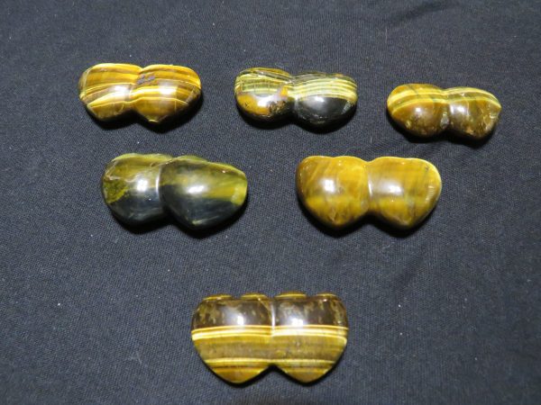 Six polished tiger's eye heart stones.