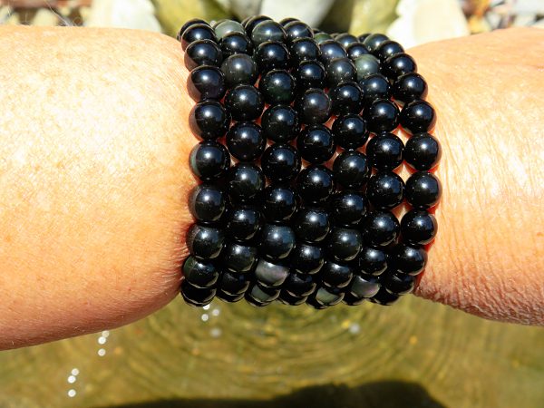 Black obsidian bead bracelet on wrist.